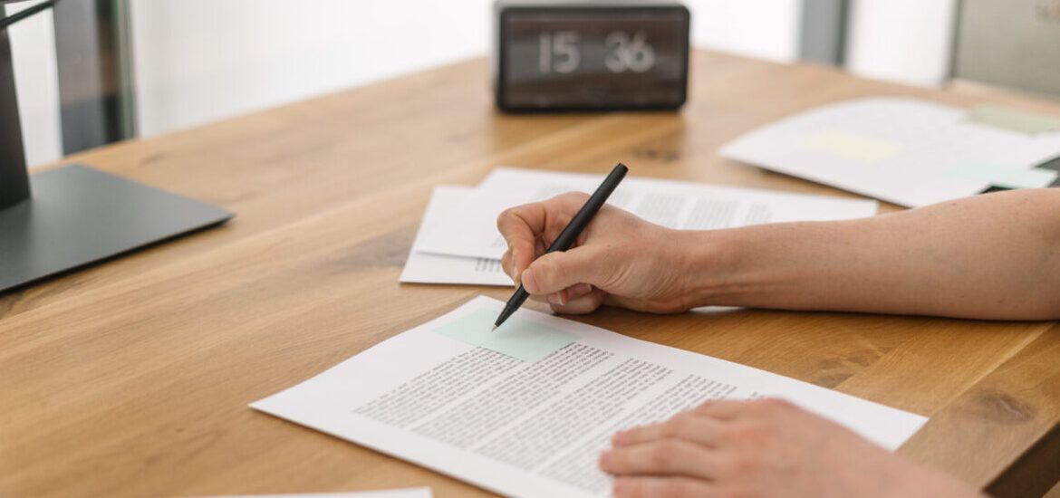 Person writing a supporting statement for a job application
